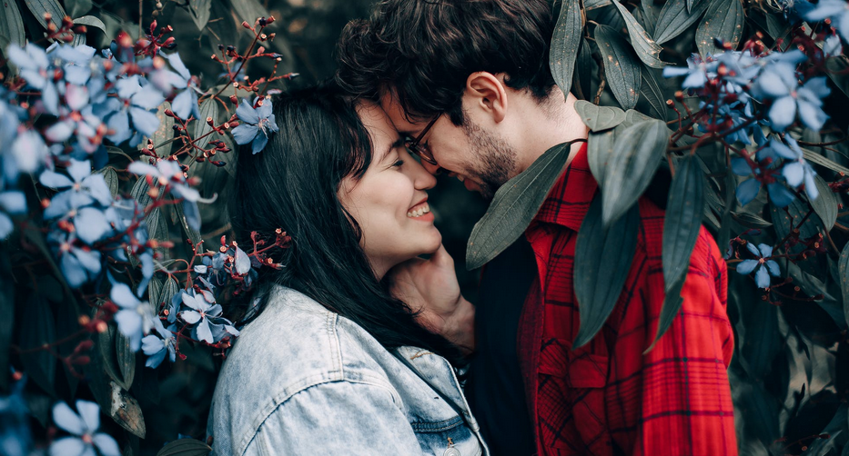 man and woman near flowers